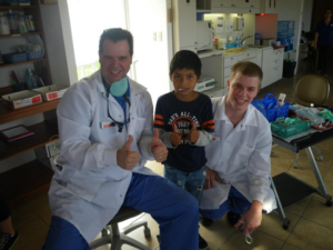 Dr. Plancich and Bryce with a Patient