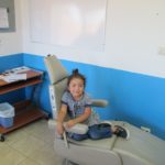 Little girl from Guatemala, sitting in a dentist chair