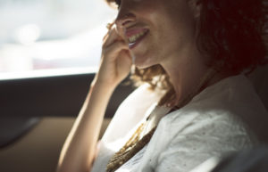 Woman smiling in car with healthy teeth