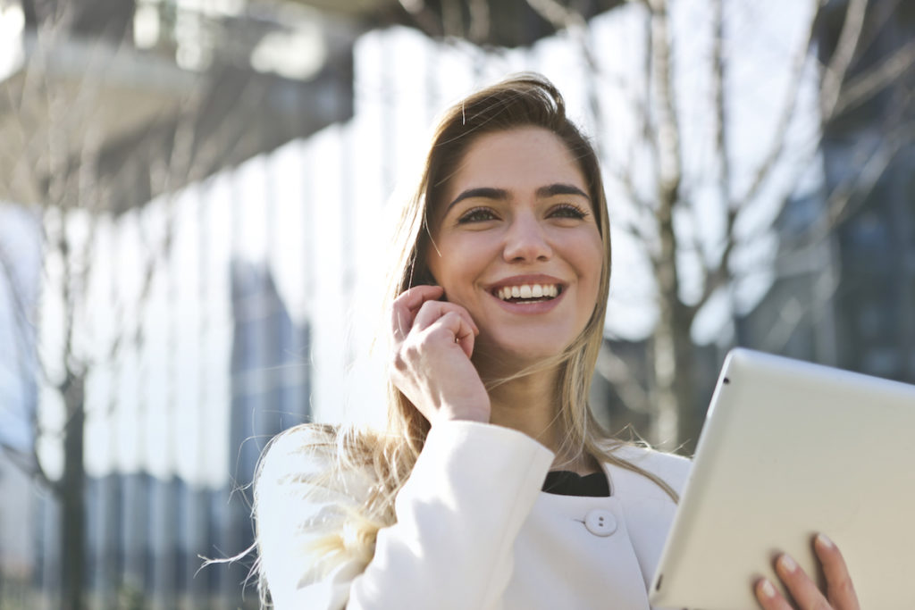 Woman smiling with iPad